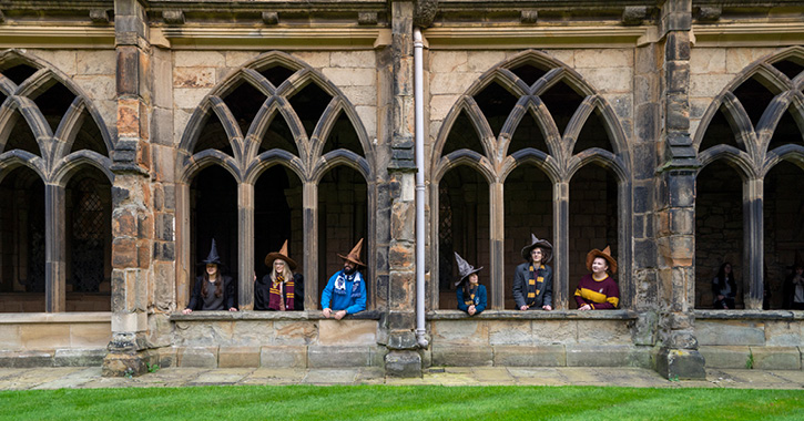 group of students dressed up as Hogwart's students at Durham Cathedral Cloisters